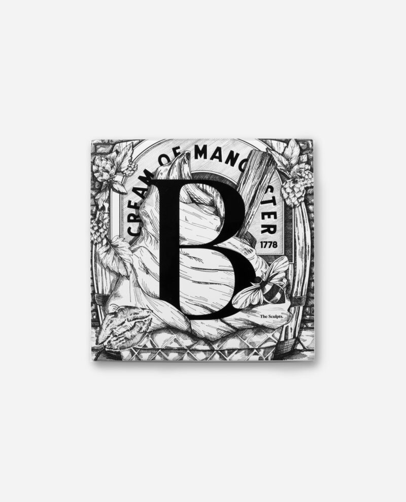 Front view of Manchester Letter B ceramic tile in black and white with botanical border, Boddingtons branding and 1778 date by The Sculpts