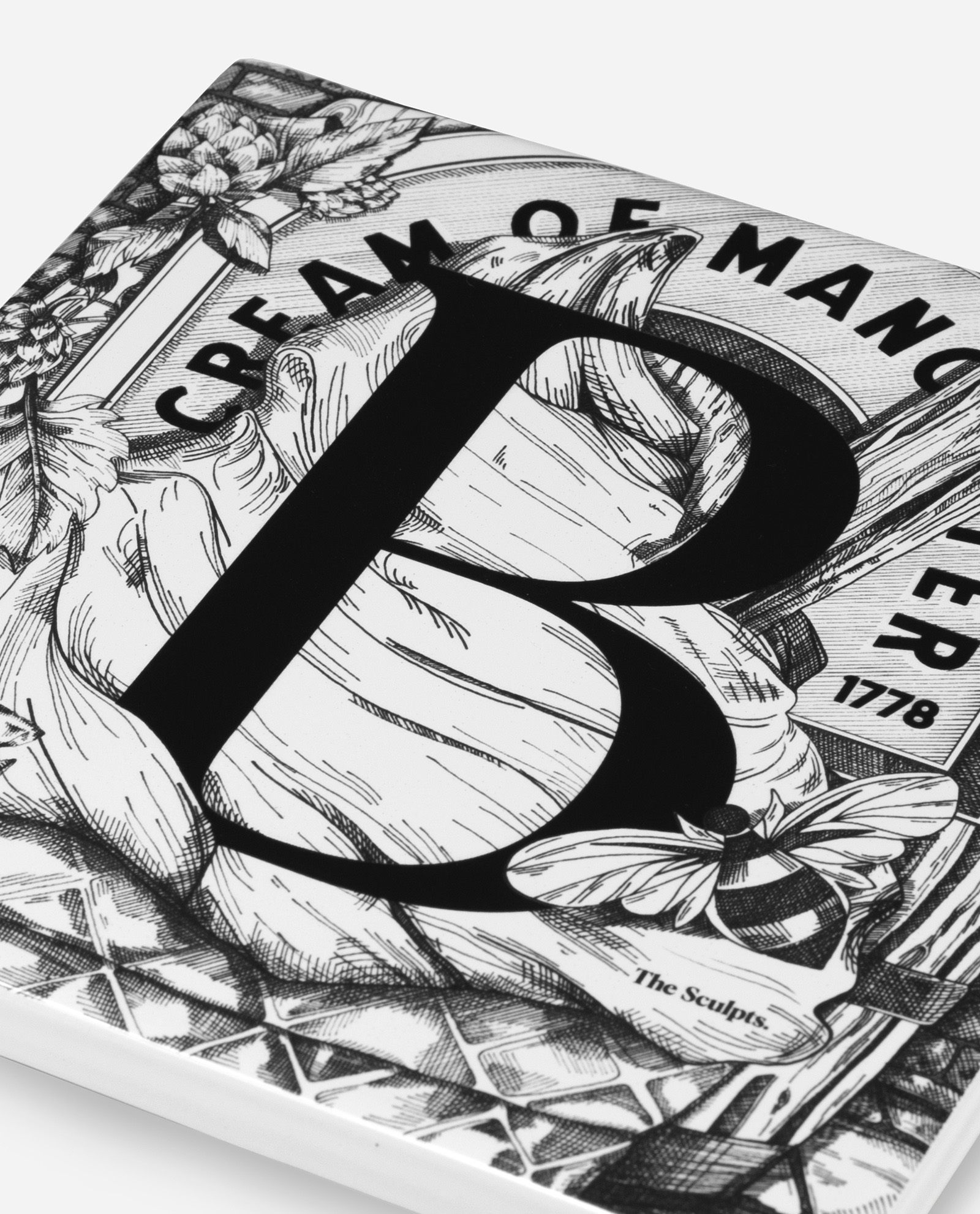 Close-up detail of Manchester Letter B ceramic tile showing cross-hatched base pattern and bold B typography by The Sculpts