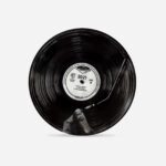 Black ceramic 2021 Year Plate with vinyl record design showing hand and white centre label marked SIDE B by The Sculpts