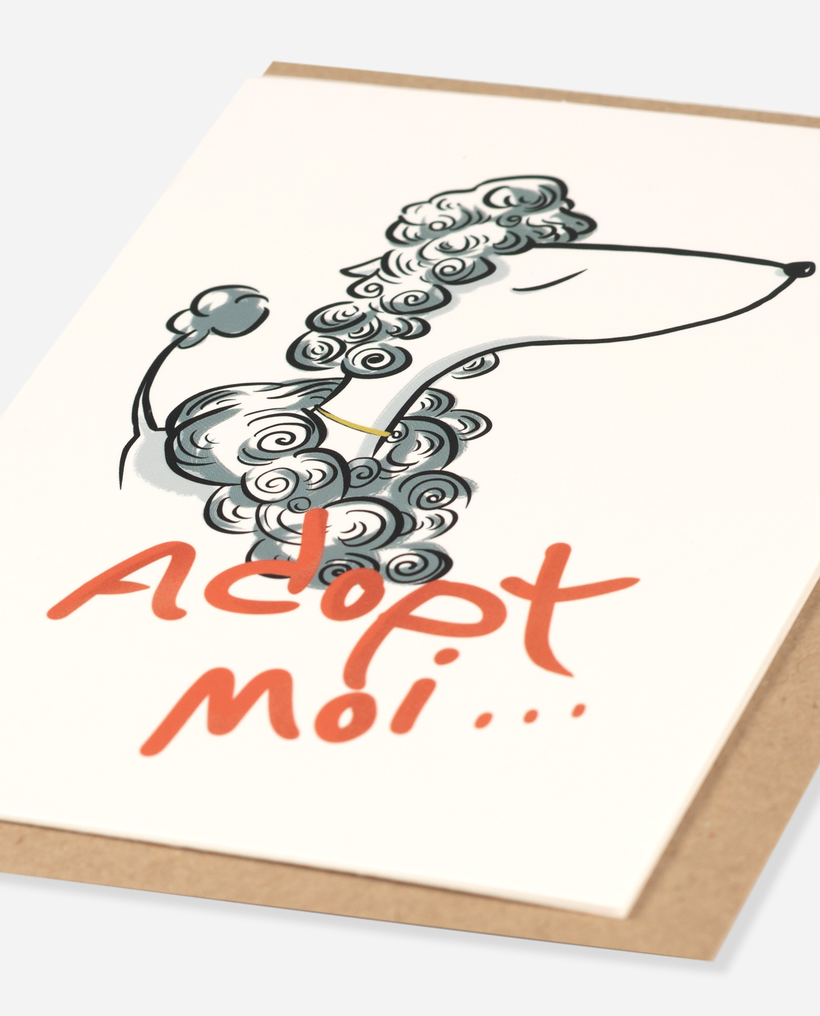 Adopt Moi dog greeting card shown at angle with grey poodle illustration and coral lettering visible on cream card
