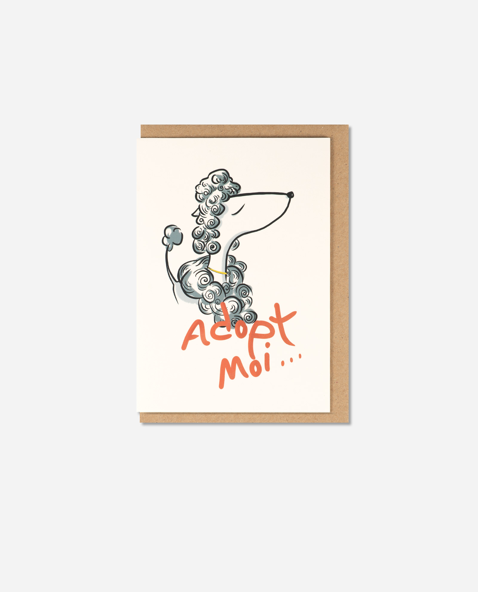 Adopt Moi greeting card flat lay showing stylised poodle illustration with coral hand lettering on cream card with kraft envelope