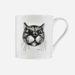 Cat mug in white bone china featuring expressive black ink drawing of cat with large eyes and whiskers