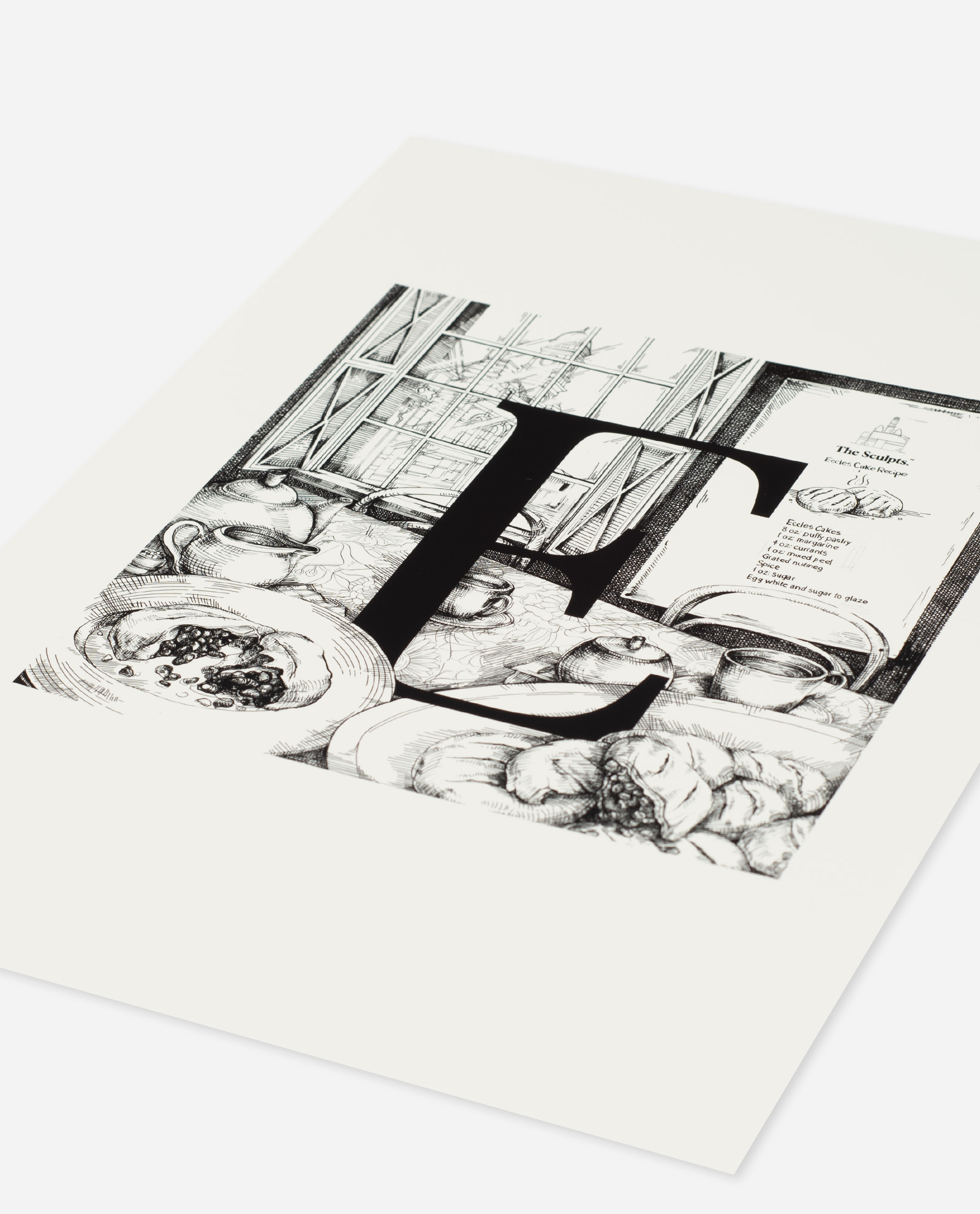 Angled view of Letter E Eccles cake print on cream paper stock showing print quality and paper texture
