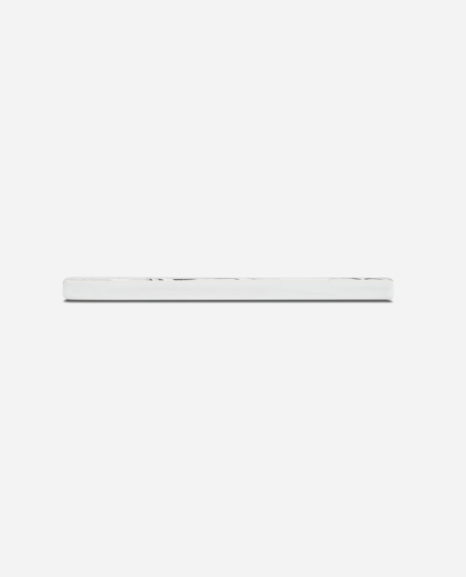 Side profile of Letter R Rocket ceramic tile showing white edge thickness against neutral background