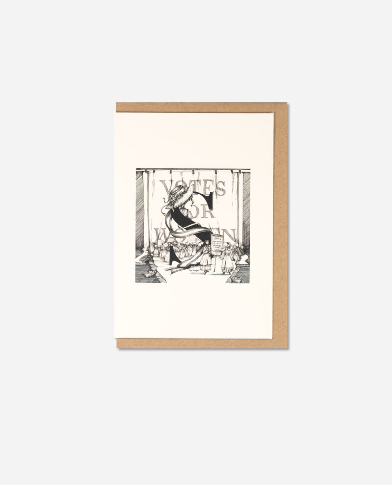 Top-down view of The Manchester Letters S for Suffragettes card on brown kraft envelope showing complete illustration and text