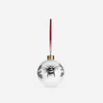 White bone china Manchester Bee Christmas bauble with black illustrated bee design and pine sprigs, hanging from red ribbon