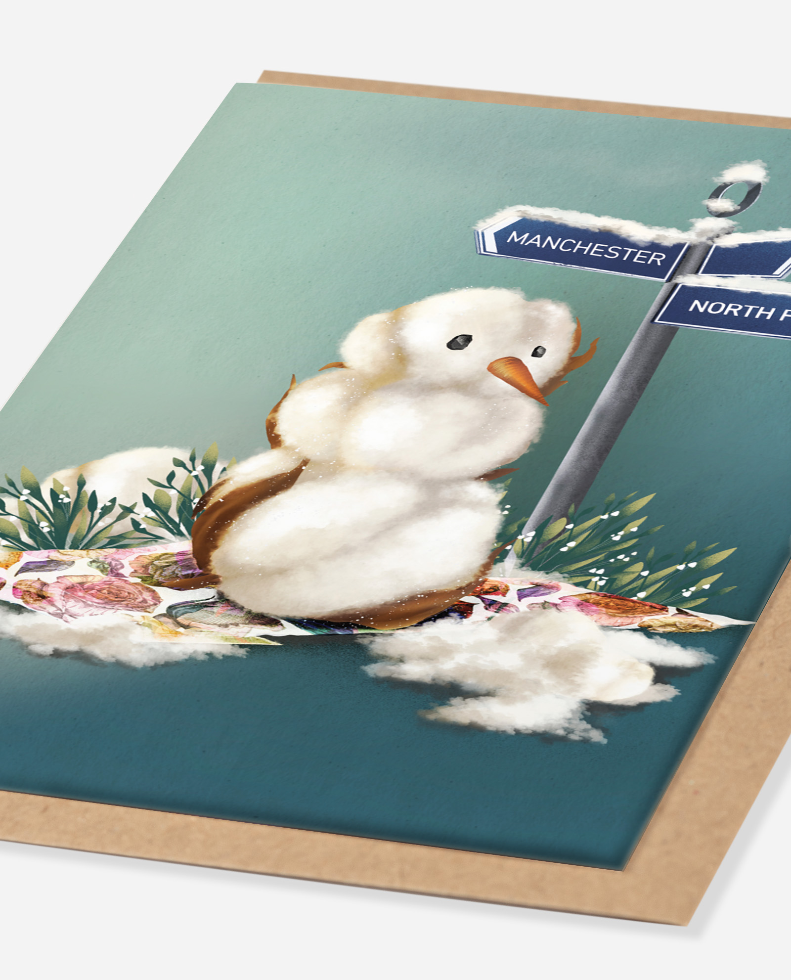 Cotton Snowman Christmas Card oblique angle view showing textured fluffy snowman detail and Manchester North Pole signpost on kraft envelope