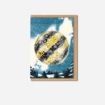 Haçienda Christmas Disco greeting card with black and yellow disco ball on snowy blue background with brown kraft envelope