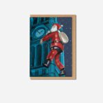 Town Hall Santa Christmas card by The Sculpts showing red inflatable Santa climbing blue Manchester Town Hall with kraft envelope