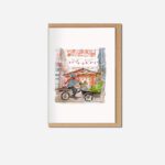 Watercolour Christmas card showing person on cargo bicycle with cockapoo riding through Manchester street decorated with red lanterns