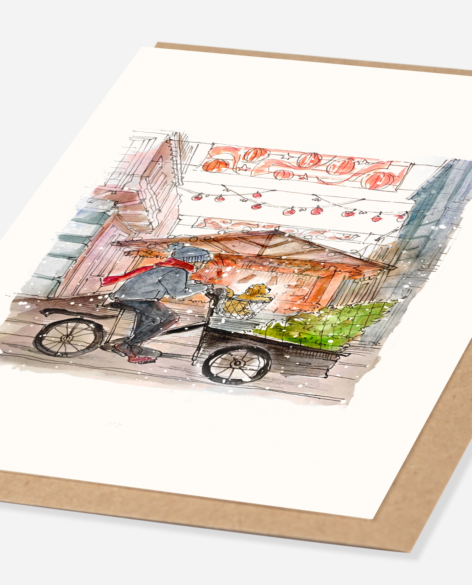Angled view of cockapoo Christmas card showing A6 watercolour illustration detail with bicycle vegetables and market decorations on white card
