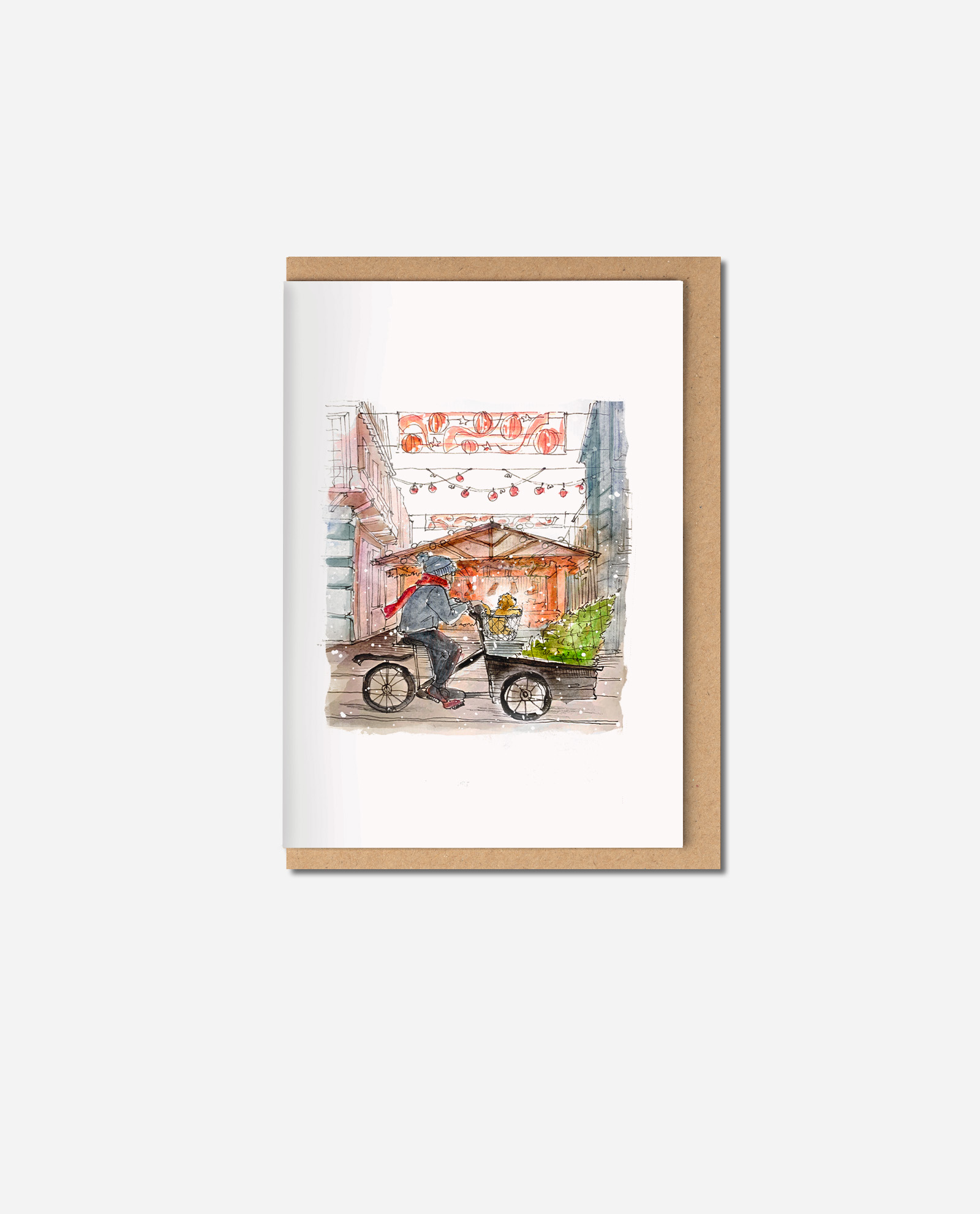 Watercolour Christmas card showing person on cargo bicycle with cockapoo riding through Manchester street decorated with red lanterns