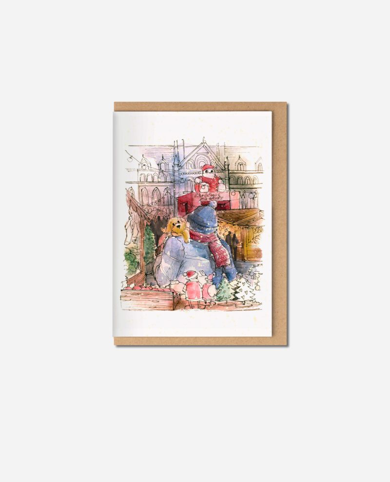 Cockapoo Christmas card with kraft envelope showing watercolour scene of dog on bicycle with Christmas tree in Manchester market setting