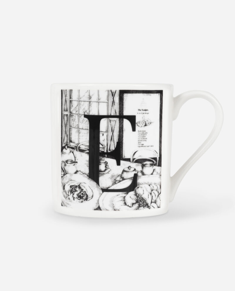 Front view of Manchester Letter E for Eccles Cake Mug showing black illustrated design with pastries and window on white china