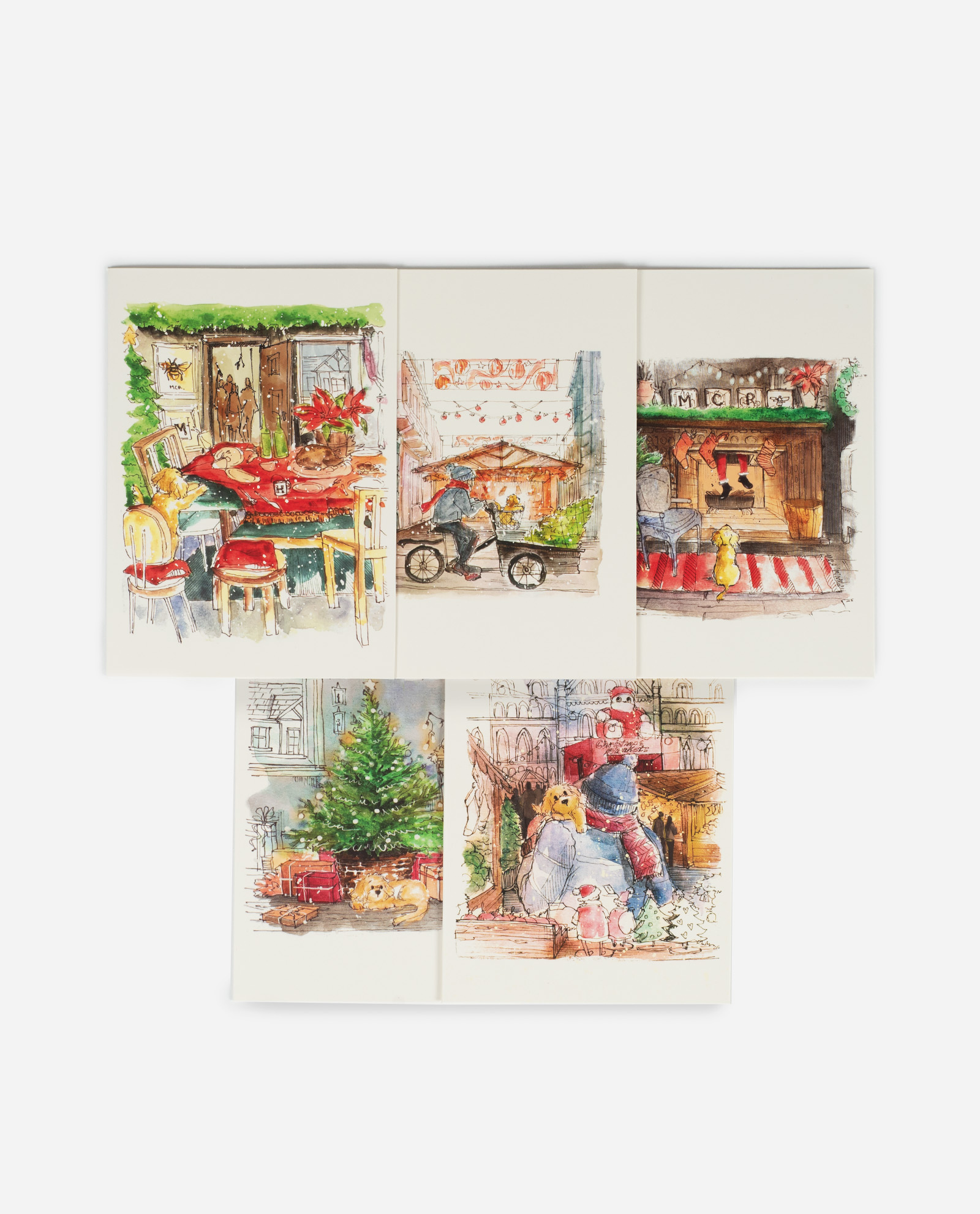 Five cockapoo Christmas greeting cards by The Sculpts arranged in two rows showing watercolour illustrations of festive Manchester scenes