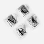 Four white Manchester mugs arranged in grid showing black illustrations of MCR landmarks and bee on fine bone china by The Sculpts