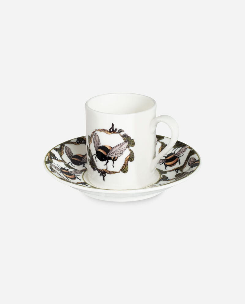 Honeycomb Bee espresso cup and saucer by The Sculpts showing white porcelain with illustrated bees and leaves in tan and olive