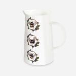 White bone china Honeycomb Bee Jug by The Sculpts shown at an angle, featuring three bumblebees in circular honeycomb wreaths with oak leaves