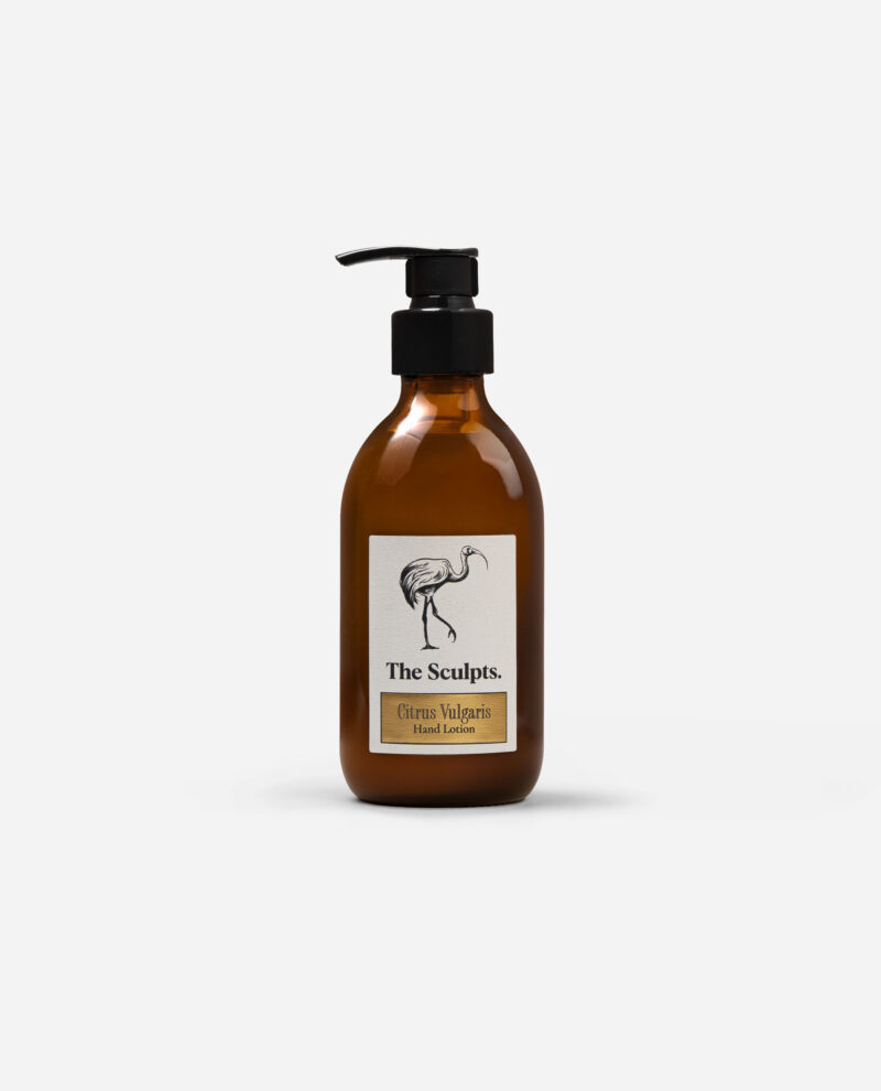 Amber glass pump bottle of Citrus Vulgaris hand lotion with black pump dispenser and cream label by The Sculpts