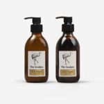Citrus Vulgaris hand wash and hand lotion in amber glass bottles with black pumps and bird illustration labels