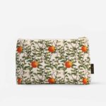 Front view of Citrus Vulgaris botanical wash bag with repeating orange fruit and green foliage pattern on natural cotton