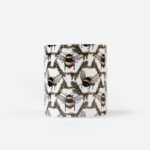 Honeycomb Bee Candle front view showing honeybees and botanical garland pattern on white cylindrical bone china vessel by The Sculpts