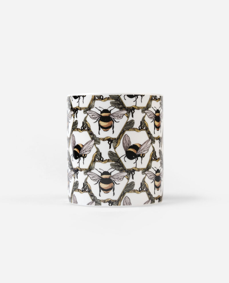 Honeycomb Bee Candle front view showing honeybees and botanical garland pattern on white cylindrical bone china vessel by The Sculpts