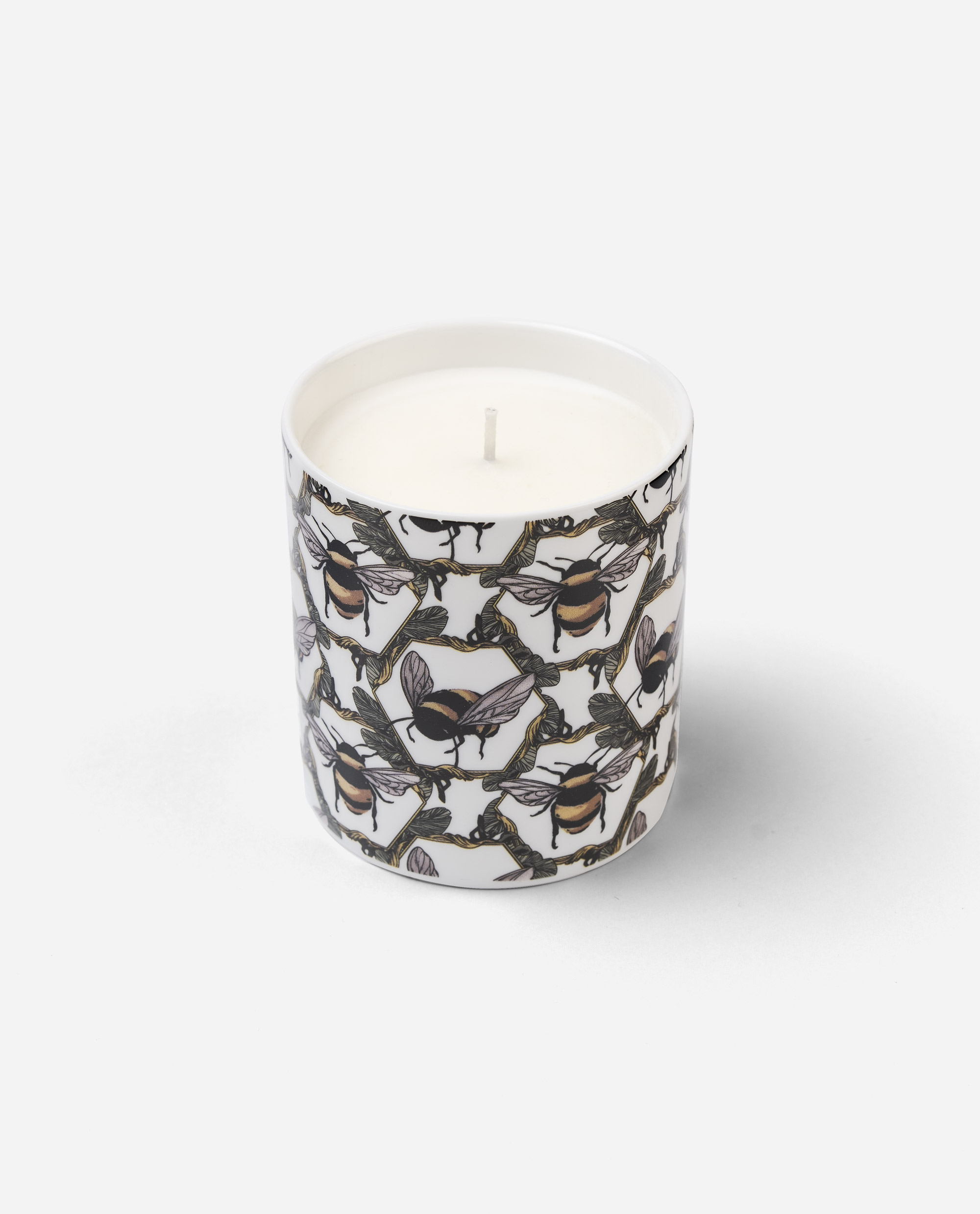 Honeycomb Bee Candle oblique angle showing white wax surface with central wick inside decorated bone china pot from The Sculpts