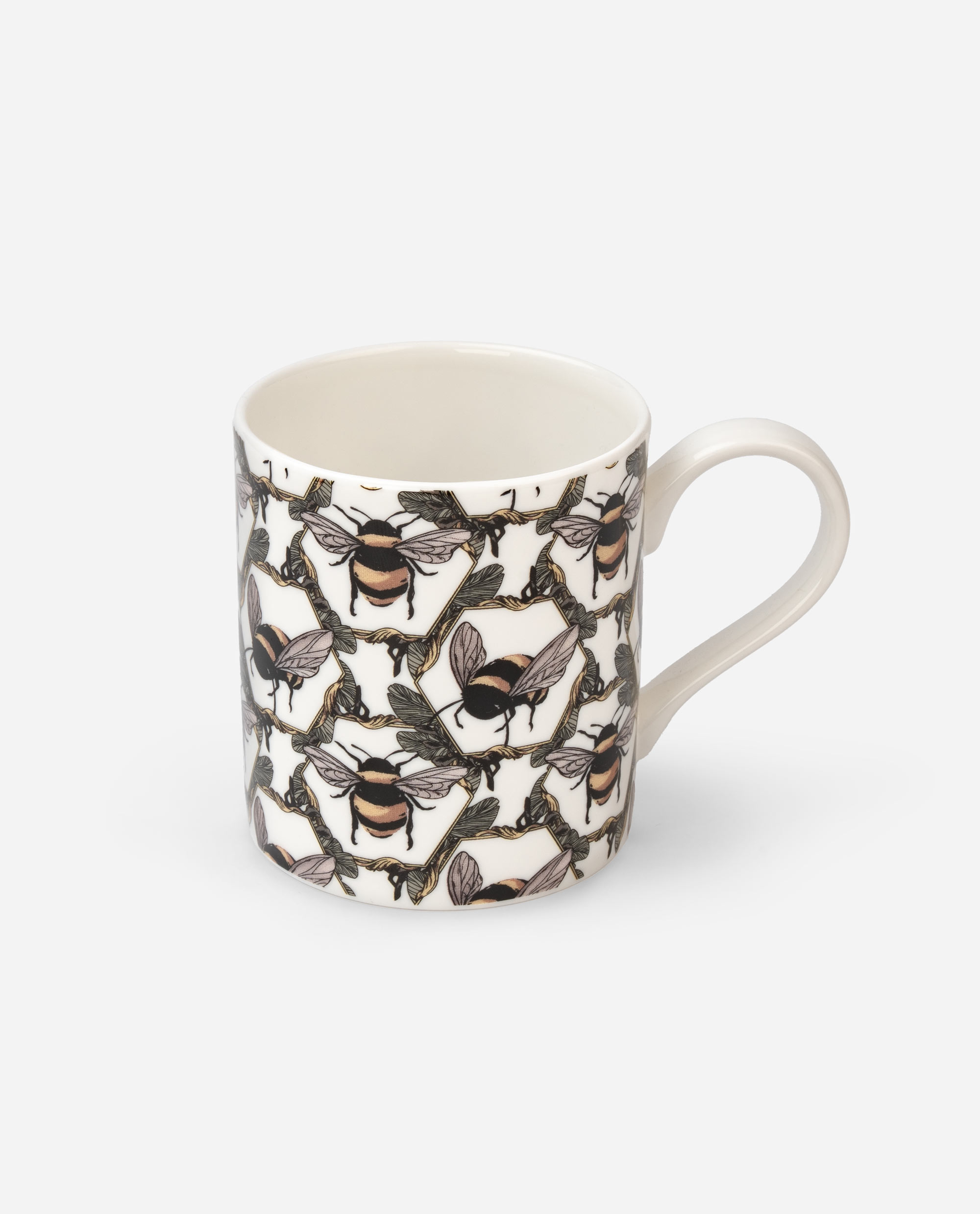 Honeycomb Bee Mug angled view showing interior rim and side pattern of bumblebees and branches on white ceramic