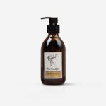 The Sculpts Honeycomb Bee Hand Wash amber bottle with black pump dispenser showing cream label