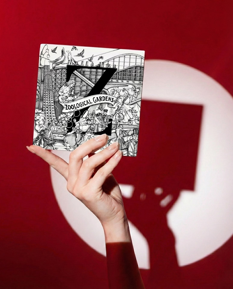 Hand holding The Sculpts Manchester A-Z tile featuring Belle Vue Zoological Gardens illustration against red background